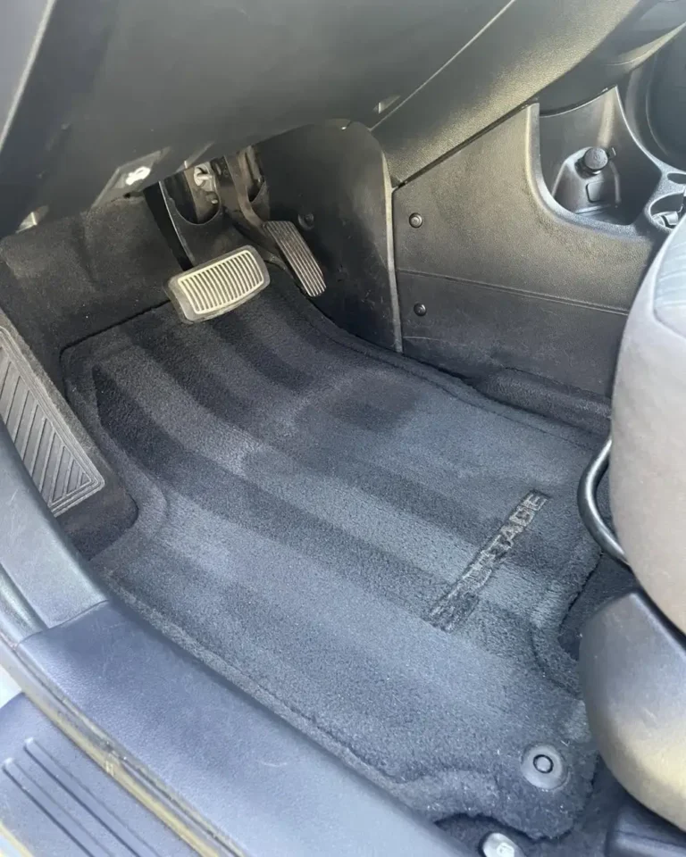 Driver floor carpet after shampoo and hot water extraction