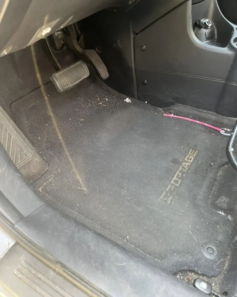 Dirty stained driver floor carpet before car carpet shampoo