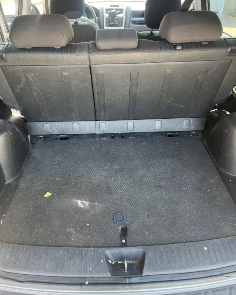 Dirty trunk cargo carpet before vacuum and shampoo