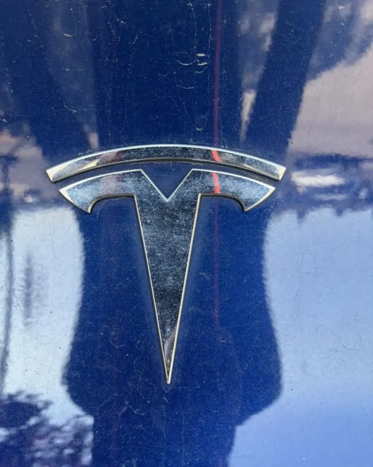 Dusty dark blue Tesla paint with water spots before exterior detail